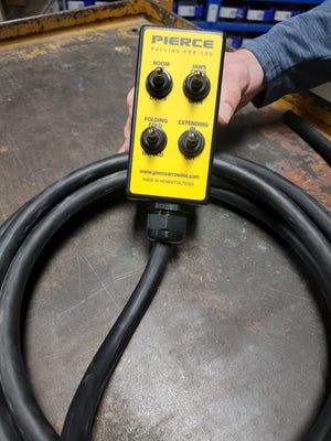 The PIERCE 8 Function Wrecker Remote includes a yellow control box with toggle switch, boom, jaws, folding, and extending capabilities. It’s attached to a thick coiled black cable, ideal for solenoid systems in towing applications.